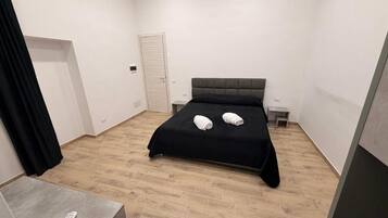 Premium Quadruple Room, Courtyard View | Desk, blackout drapes, soundproofing, iron/ironing board