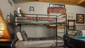 Un lit superposé avec un matelas matelassé, un oreiller et une couverture.