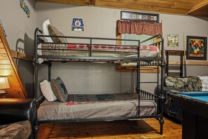A bunk bed with a quilted mattress, a pillow, and a blanket. - New Listing Hot Tub, Pool Table, Free Attractions (Sevierville)