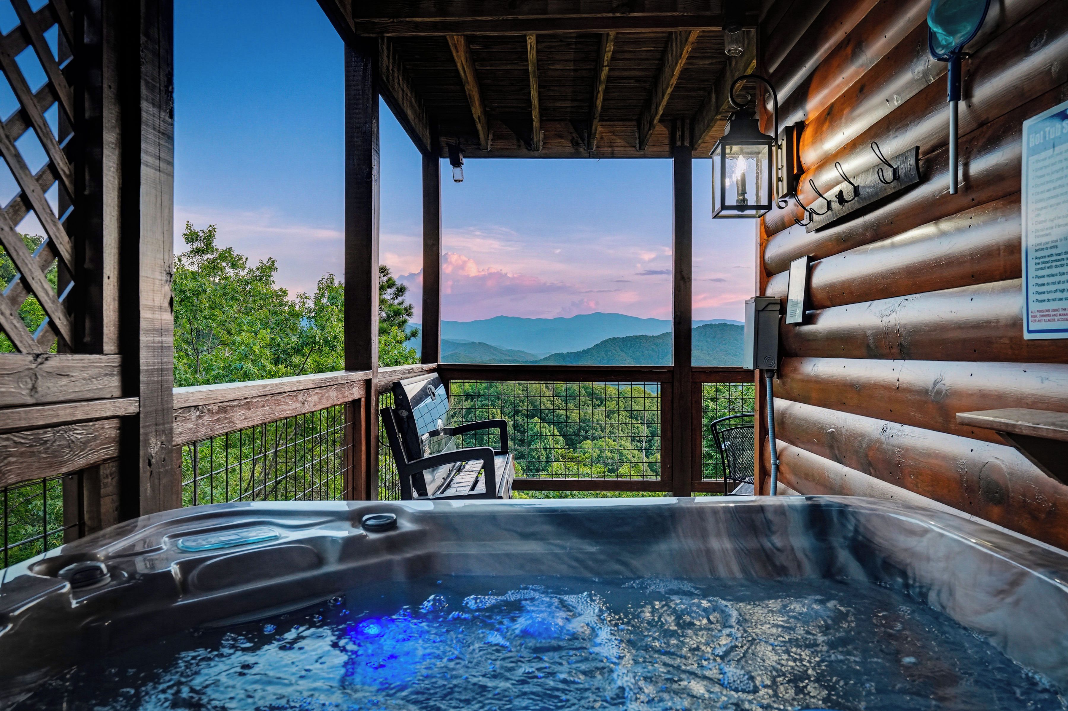 A hot tub with a view of mountains and trees.