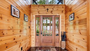 A wooden hallway with a double door, framed pictures on the walls, and a rug on the floor. - New Listing, Game Room, Hot Tub, Free Attractions, Mountain View (Sevierville)