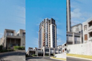A multi-story building with a modern design, featuring a prominent entrance and a clear sky in the background. - Sandton Skye apartment, convenience and comfort for your stay (Sandton)