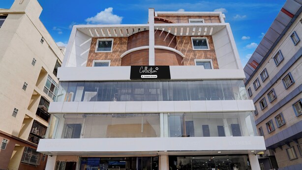 A multi-story building with a prominent 'Collection' sign, large windows, and a visible staircase leading to the entrance. - Collection O Sarjapura Road Kasavanahall (Bengaluru)