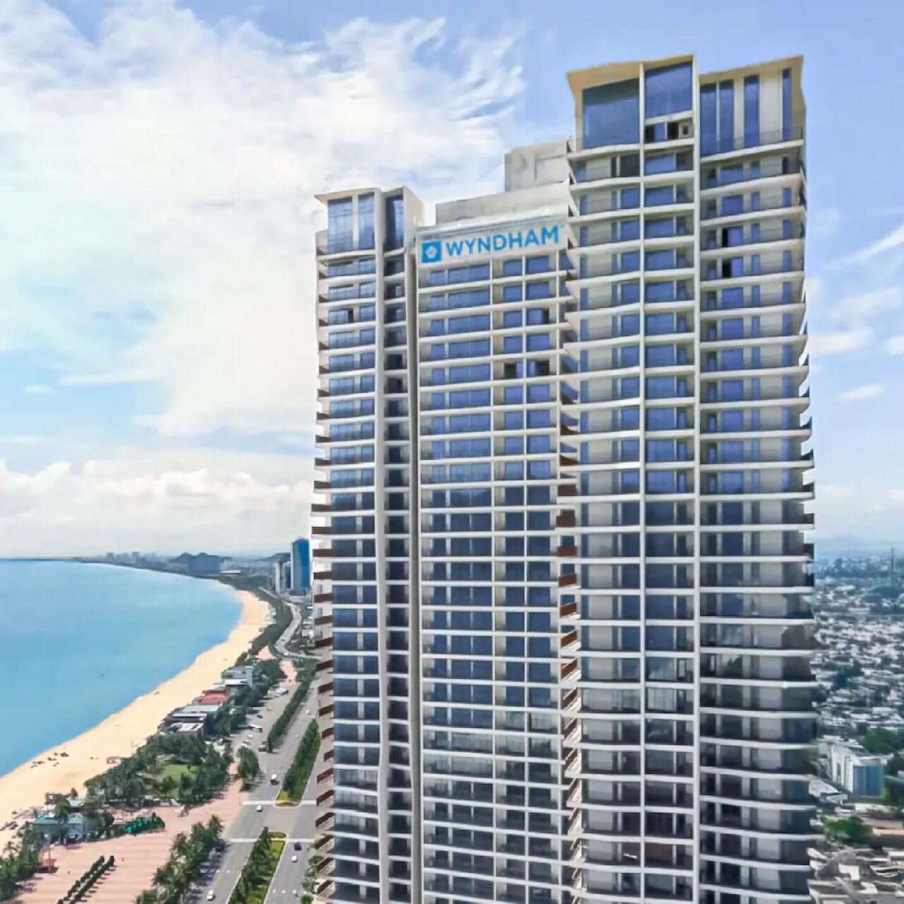 A high-rise building with a clear view of the beach and ocean.