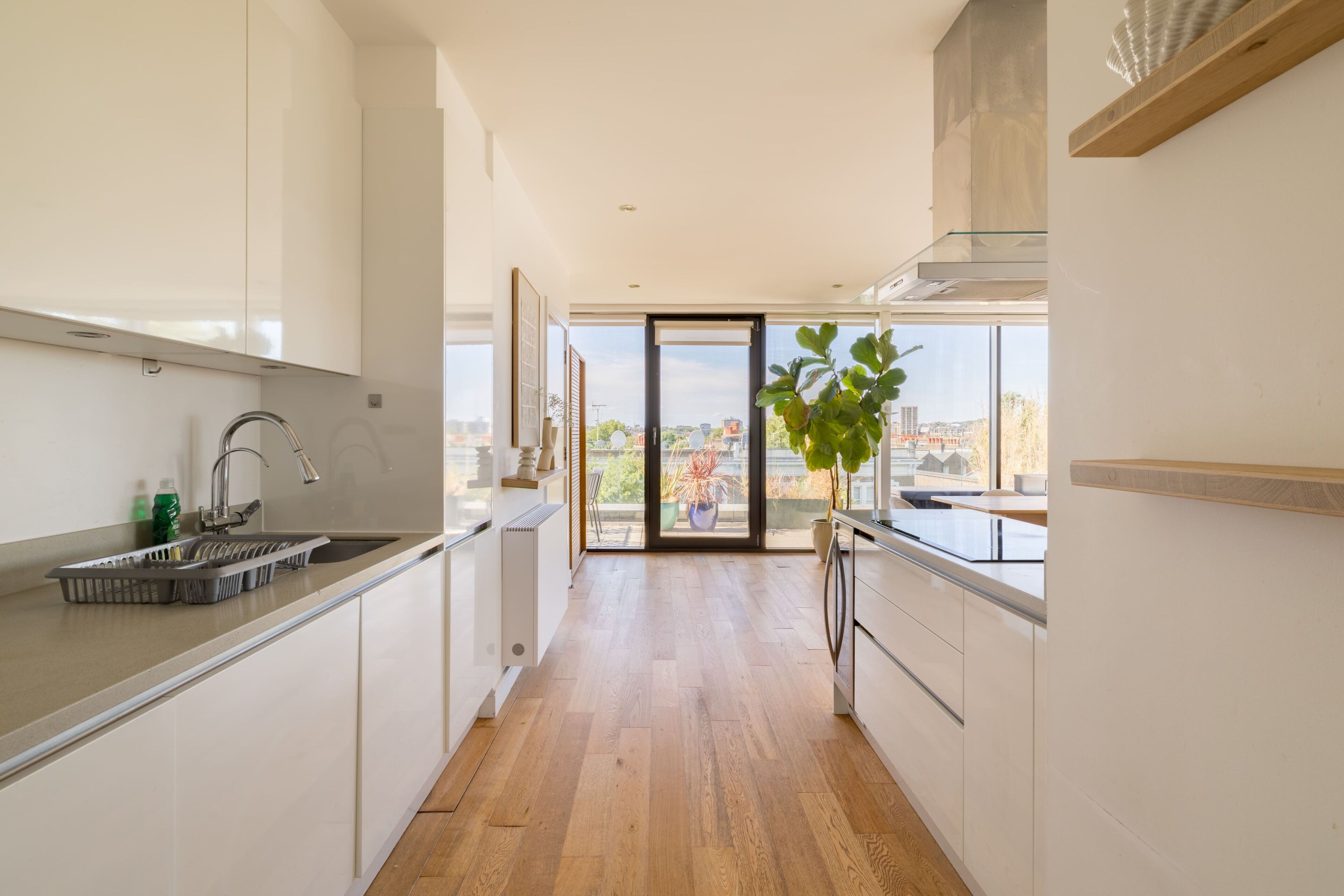 A modern kitchen with a view of the city through large windows.