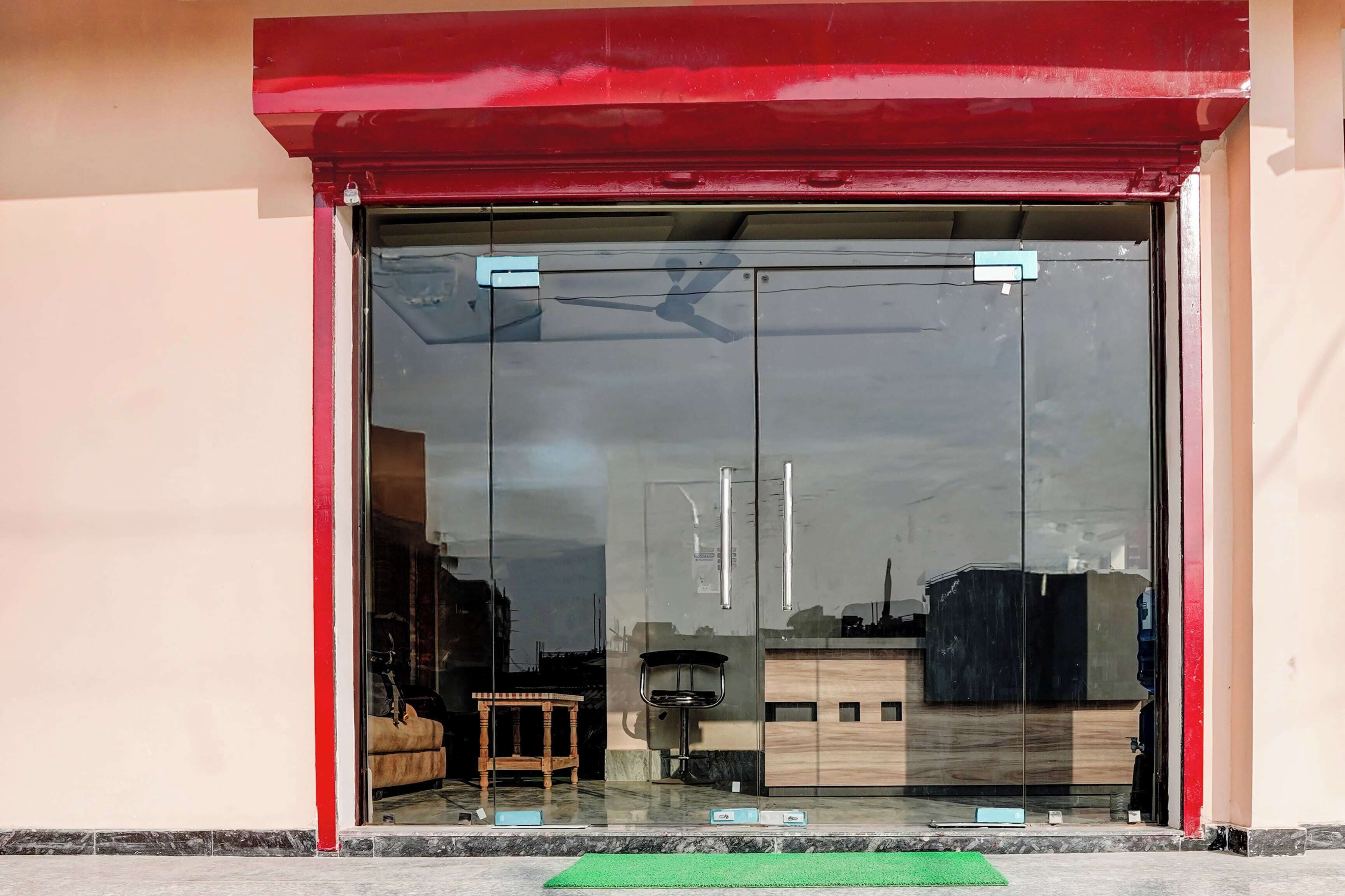 A building entrance with a glass door and a red awning.