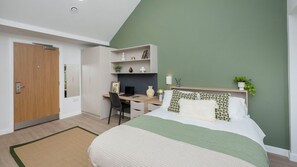 A bedroom with a bed, a desk, and a wardrobe. - Student Only Waterloo House (York)