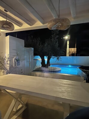 A modern indoor pool area with a tree, a hot tub, and a table. - Family home in an Alentejo village (Amieira Portel)