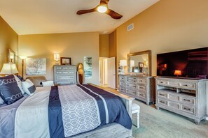 A bedroom with a bed, dresser, TV, and ceiling fan. - Work & Play in Indio: Golf Course Home w/ Patio (Indio)
