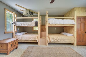 A room with two bunk beds, a wooden dresser, and a window. - Dock, Fire Pit, Games! Spirt Lake Family Retreat (Frederic)