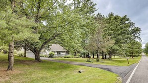 A residential street with houses, a driveway, and a road. - Game Room, Deck + Yard! Cadillac Family Escape (Cadillac)