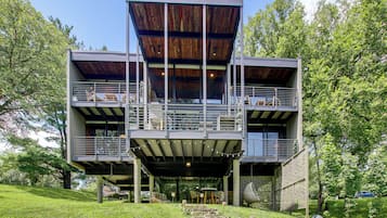 A modern multi-level building with outdoor seating and a covered area.