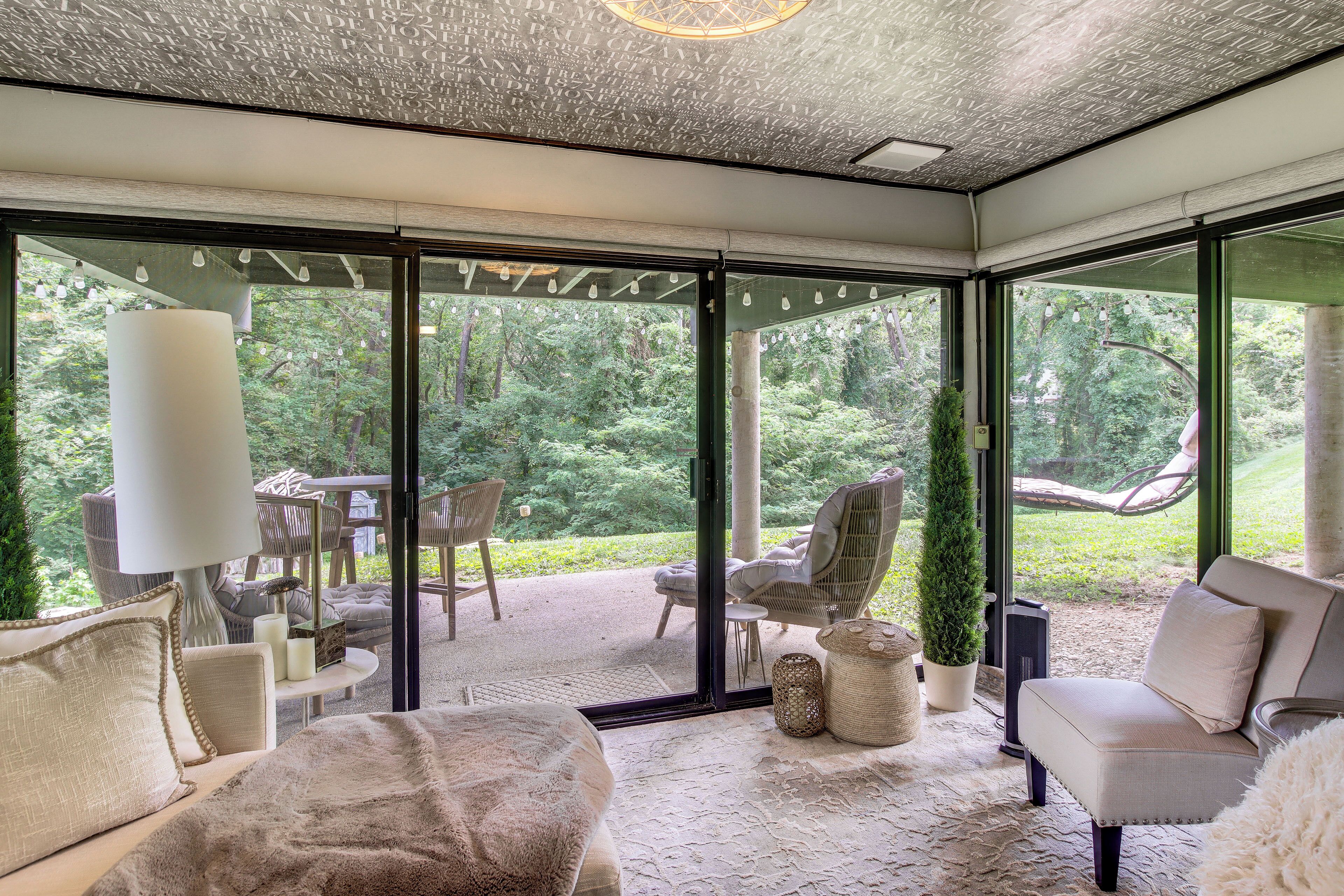 A modern interior with a glass door leading to a garden.