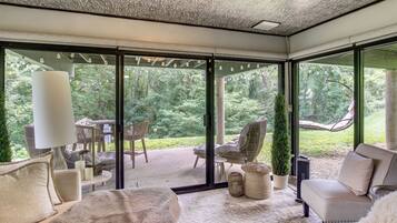 A modern interior with a glass door leading to a garden.