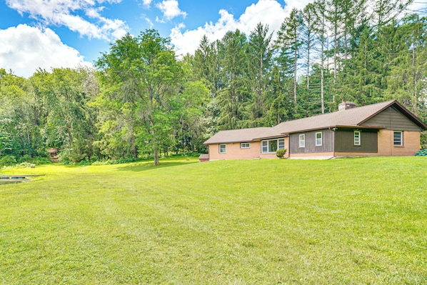 A single-story house with a sloped roof, a front porch, and a well-maintained lawn.