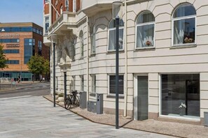 A building with a classic architectural style, featuring large windows and a flat facade.