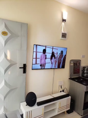 A modern kitchen with a built-in oven, a microwave, and a stove.