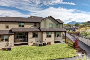 A two-story house with a covered porch and a well-maintained lawn. - Grill-Mnt Views-Private Hot Tub-King Bed-Sleeps 12 | Moose Mgmt 1132 (Park City)