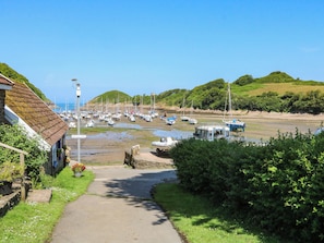 A coastal pathway leading to a marina with boats docked. - Seagull Lodge (Ilfracombe)