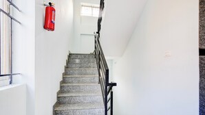 A staircase with granite steps and black railings, leading to a landing with a window. - Super Collection O Uttarahalli (Bangalore)