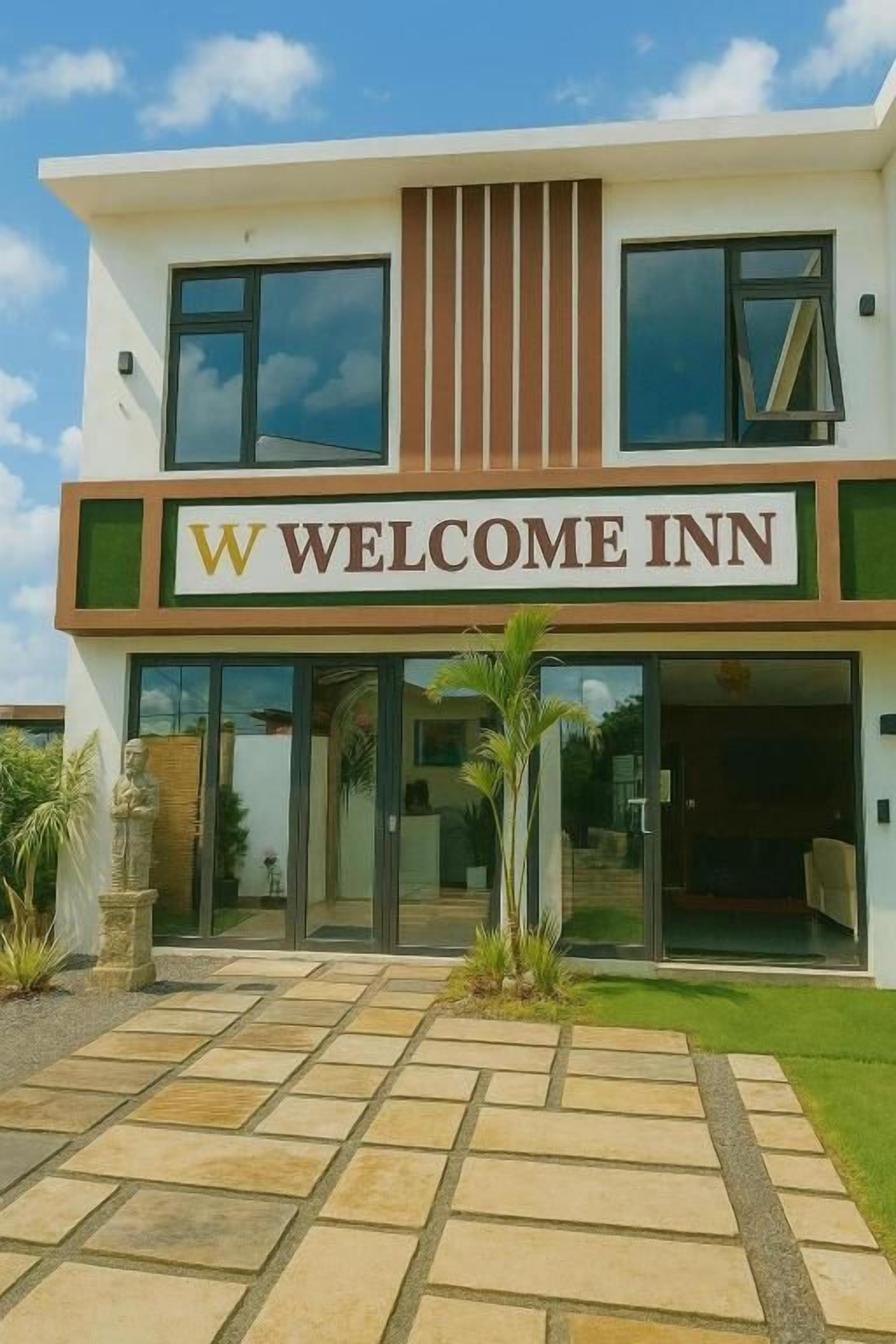 A modern building with a sign reading 'WELCOME INN'.