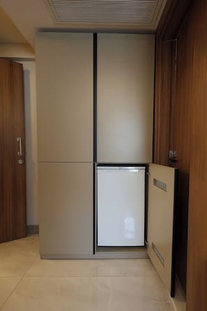 A compact kitchen with a built-in refrigerator and a microwave. - Kalkan Hotel (Istanbul)