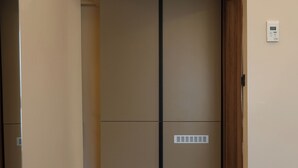 A room with a sliding door closet, a built-in air vent, and a thermostat on the wall. - Kalkan Hotel (Istanbul)