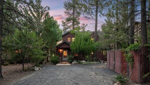 A rustic log cabin with a stone driveway leading to the entrance. - NEW Lakefront (Location, about the cabin, game room, and more!) (Big Bear Lake)