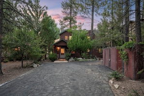 A rustic log cabin with a stone driveway leading to the entrance. - NEW Lakefront (Location, about the cabin, game room, and more!) (Big Bear Lake)
