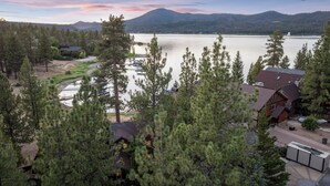 A lakeside property with a dock, cabins, and a mountain backdrop. - NEW Lakefront (Location, about the cabin, game room, and more!) (Big Bear Lake)