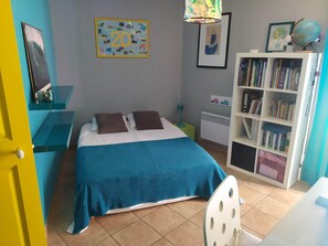 A bedroom with a bed, a bookshelf, a desk, and a door. - A very shady villa with a pool and a large garden featuring 29 oak trees. (Pélissanne)