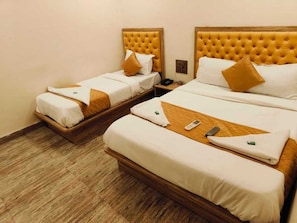A hotel room with two beds, each with a wooden headboard and white bedding. There is a telephone on the nightstand next to the beds. - Hotel Royce BKC (Mumbai)