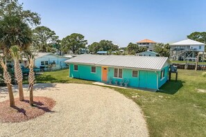 Exterior - Walk to Mashes Sands Beach, boat from your private dock, and bask in Old Florida in this one-story canal-front home (Panacea)