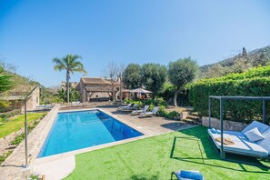 A swimming pool with lounge chairs and a grassy area. - Historic Villa With Mountain Views, Mallorca (Pollença)