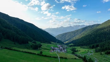 Ein Tal mit einem kleinen Dorf, umgeben von Bergen.