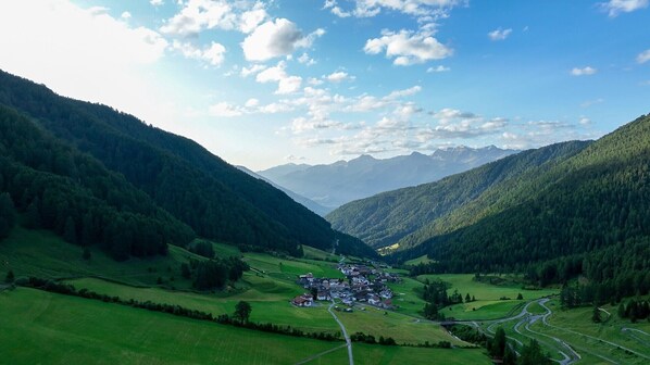 A valley with a small village surrounded by mountains.