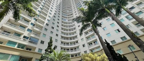 A high-rise hotel with multiple balconies and a central entrance.