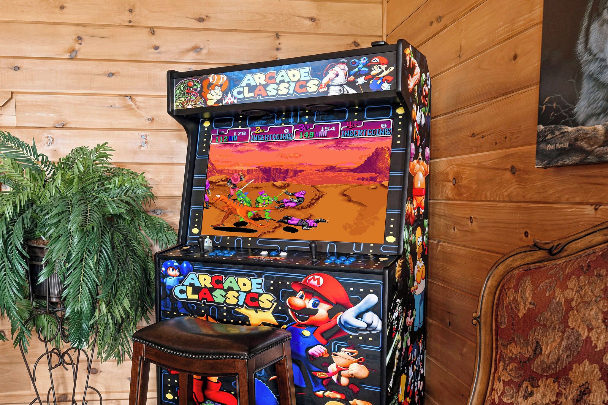 A retro arcade machine with a Mario character, surrounded by wooden paneling and a potted plant.