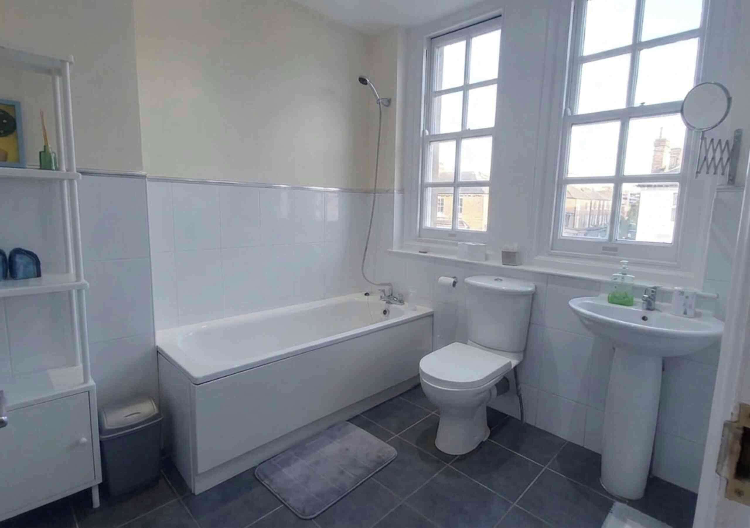 A bathroom with a bathtub, toilet, and sink.
