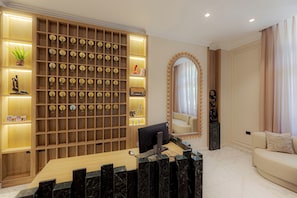 A modern reception desk with a computer, a large mirror, and a wall of circular plaques. - AJIRA Zamalek Hotel (Cairo)