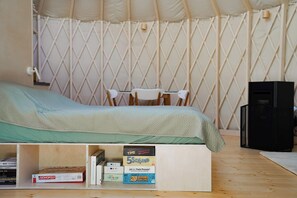 A tent with a bed, a table, chairs, and a speaker. - Restart Kashubia - Yurt in a Landscape Park (Dejk)