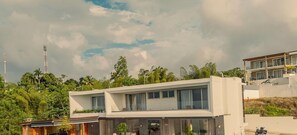 A modern two-story building with large windows and a balcony. - Villa Rose (Las Terrenas)