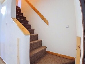 A carpeted staircase with wooden handrails, leading to a room with white walls and a door. - Cosy apartment in villa for 12 people with WIFI, TV and patio (Vrchlabí)