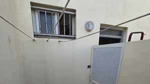 A small enclosed space with a window, a door, and a tiled floor. - Wonderful 2-bedroom condo in Essaouira perfect for relaxing stays (Essaouira)