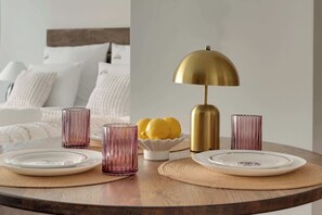 A dining table with plates, glasses, and a lamp. - Scala 16 | Parking | City Center (Gdańsk)