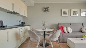 A modern living space with a kitchen, dining area, and seating area. - Nowa Motława B48 | Riverside | City Center (Gdańsk)