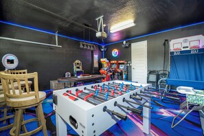A room with a foosball table, arcade games, and a basketball hoop. - Luxury Disney Escape - Pool, SPA and Games (Kissimmee)
