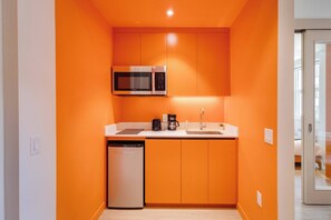 A compact kitchen with a microwave, coffee maker, and dishwasher. - 313 Cook - Apartment in Old Quebec (Québec)