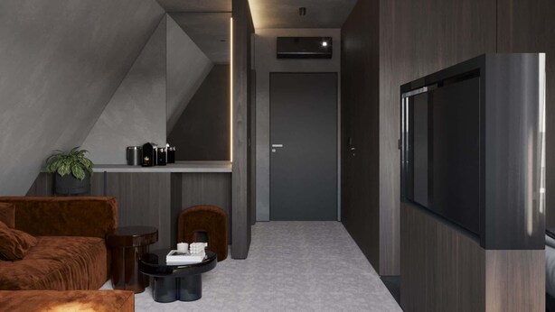Un interno moderno con un divano, un tavolino da caffè e una televisione a schermo piatto.