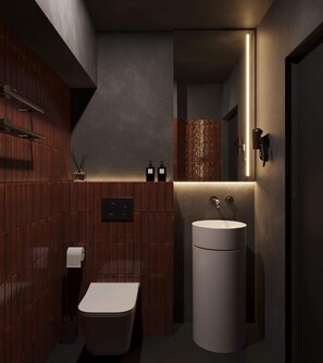 Ein modernes Badezimmer mit Toilette, Waschbecken und Spiegel.